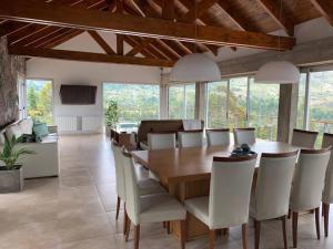 a dining room with a wooden table and chairs at La Cumbrecita ,Casona super Lujo . in La Cumbrecita