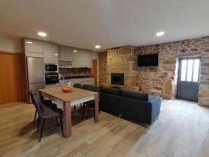 a living room with a table and a couch at Refúgio do Côa - Pure Countryside Experience in Pinhel