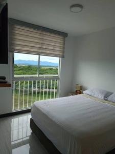Un pat sau paturi într-o cameră la Puerto Azul Club House - Ricaurte Cundinamarca