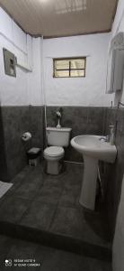 a bathroom with a toilet and a sink at Ocean View in Puntarenas
