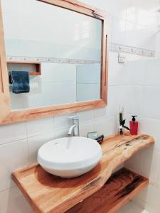 a bathroom with a white sink and a mirror at Hakuna Matata Villa in Paje