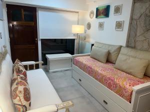 a bedroom with a bed and a couch and a desk at Casamia Studio in Bahía Blanca