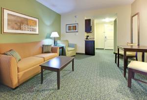 a living room with a couch and a table at Holiday Inn Express & Suites Covington by IHG in Covington