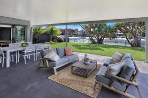 A seating area at MOOLOOLABA CANAL HOME - Modern 4Bedroom with Spa, Sauna and Private Pontoon - NEW proprietor 2024