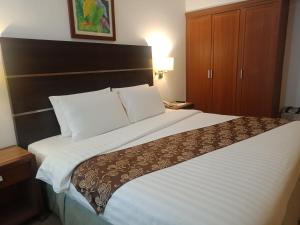 Postel nebo postele na pokoji v ubytování Days Hotel by Wyndham Iloilo