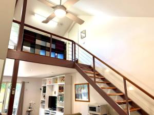 a staircase in a house with a ceiling fan at Shore to Please 1 bdrm loft apt Beach Wifi in Henley Beach South