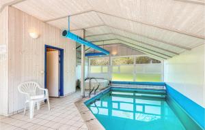 a swimming pool in a house with a ceiling at Poolhaus 1 In Hohendorf in Hohendorf