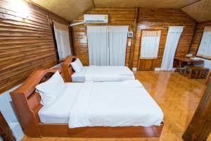 A bed or beds in a room at Panya Garden Resort