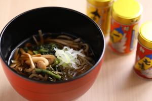 a red bowl of food with noodles and vegetables at Onyado Nono Matsumoto Natural Hot Spring in Matsumoto