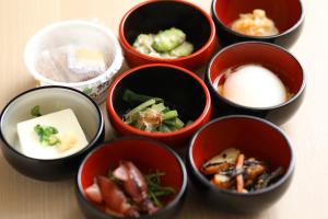 a group of bowls filled with different types of food at Onyado Nono Matsumoto Natural Hot Spring in Matsumoto