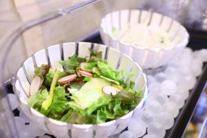 a salad in a white bowl on a tray at Onyado Nono Matsumoto Natural Hot Spring in Matsumoto