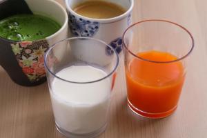 two glasses of milk and a cup of orange juice at Onyado Nono Matsumoto Natural Hot Spring in Matsumoto
