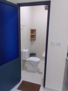 a bathroom with a white toilet in a room at For Women Only - للنساء فقط in Umm el ‘Amad