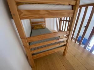 a bunk bed in a room with a staircase at Charmante maison de ville in Monflanquin