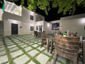 a patio with a table and chairs and a building at Hostel ivory in Jaipur