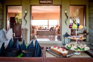 a buffet with cakes and desserts in a living room at Makumu Private Game Lodge in Klaserie Private Nature Reserve