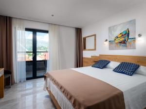 Ein Bett oder Betten in einem Zimmer der Unterkunft Hotel D'Elegant Dubrovnik