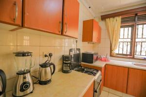 a kitchen with a blender on a counter at Prax suits in Kampala