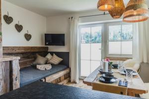 a living room with a couch and a table at Landhaus Theresia in Maria Alm am Steinernen Meer