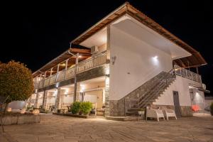 a large white building with stairs on the side of it at Bella Terra Nature Living in Asprovalta