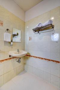 a bathroom with a sink and a mirror at Hotel Silver Inn in Mahabaleshwar