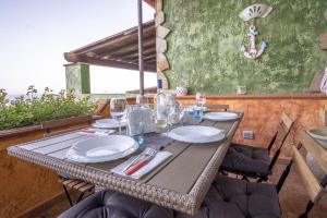 a table with plates and wine glasses on a patio at Porto Corallo Frontemare in Villaputzu