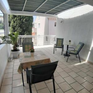 a patio with chairs and a table on a patio at Guesthouse MM in Dubrovnik