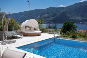a swimming pool with a view of a mountain at Villa Dea in Kotor