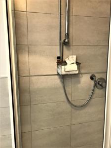 a shower with a shower head in a bathroom at Few Steps from Vatican City in Rome