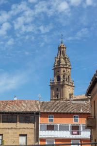 a building with a clock tower in the background at La casa del mercadillo, Haro in Haro
