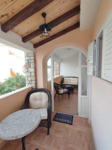 un patio con tavolo e sedie sul balcone. di Apartment Sandrica a Stomorska
