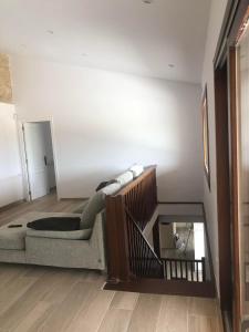 a living room with a couch and a mirror at Finca Clos in Borrassá