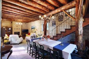 een eetkamer met een tafel en stoelen en een trap bij KANTARA HOUSE - A Rural Retreat of Comfort & Class! in Arsos