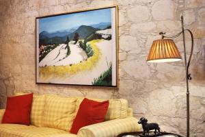 a living room with a couch and a painting on the wall at KANTARA HOUSE - A Rural Retreat of Comfort & Class! in Arsos