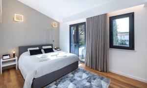 a bedroom with a large bed and a large window at Medusa Luxury Marina in Vilamoura +37 photos