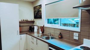 a kitchen with a sink and a window at Adventure Bay Holiday Home in Adventure Bay