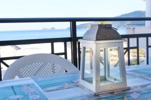 a lantern sitting on top of a table on a balcony at Waves Studios in Chrysi Ammoudia