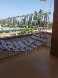 a hammock on top of a building with a pool at Marina dor Frontal 1ª línea in Oropesa del Mar