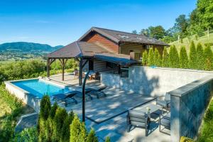 a villa with a swimming pool and a house at Ville Pačetina in Lepajci