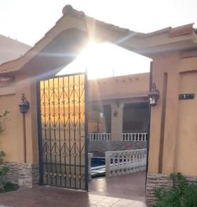a gate in a house with the sun shining through it at استراحة توسكانا Toscana Villa in Obhor