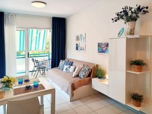 a living room with a couch and a table in it at Apartment Pine Wood in Bibione