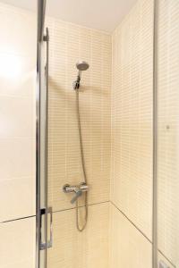 a shower with a shower head in a bathroom at Loft Santa Lucia Centro in Málaga