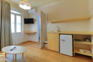 a kitchen with a white refrigerator and a table at athensvintage in Athens