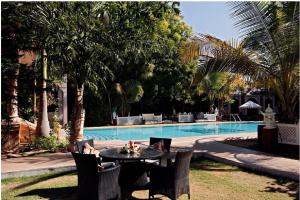 a table and chairs in front of a swimming pool at Ranbanka Palace in Jodhpur