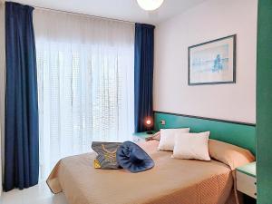 a bedroom with two beds and a window at Apartment Pine Wood in Bibione