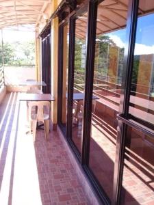 a screened in porch with a table and chairs at ASHBURN'S TRANSIENT BAGUIO- Dorm rooms 6th floor in Baguio