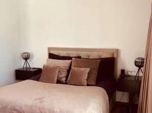 a bedroom with a large bed with two lamps at AHT22 premium beach residence in Pärnu