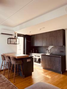 派爾努的住宿－AHT22 premium beach residence，厨房配有黑色橱柜和木桌