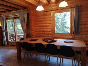 a dining room with a wooden table and chairs at Chalet de charme authentique in Bolquere Pyrenees 2000