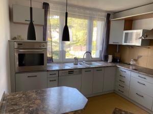 a kitchen with a sink and a stove top oven at Apartament w ZIELONEJ OKOLICY z TARASEM in Kielce